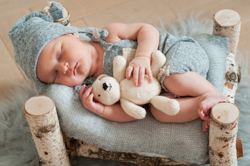 Newborn baby sleeping, asleep on bed