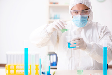 Fototapeta premium Young chemist student working in lab on chemicals