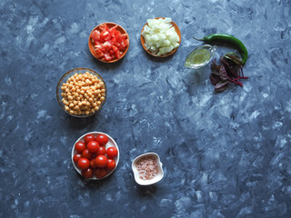 Set of vegetables with chickpeas on grey background. Sliced vegetables for cooking.