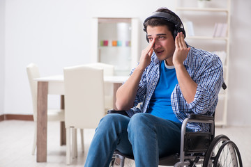 Fototapeta na wymiar Disabled man listening to music in wheelchair