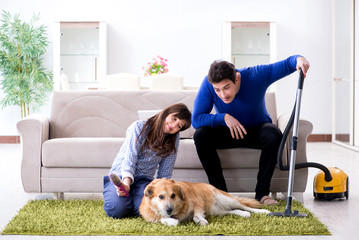 Husband cleaning house from dog fur