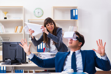 Employee with virtual reality glasses in office