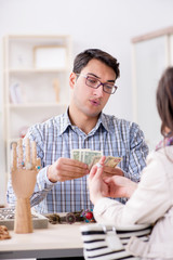 Woman visiting jeweler for jewelery evaluation