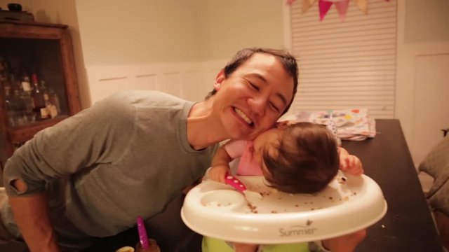 Dad and Baby Eskimo Kiss at Dinner Table