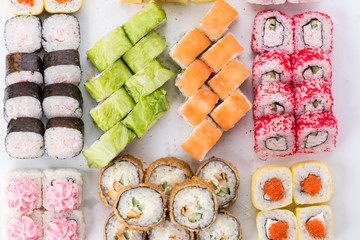 Sushi set and composition at white background. Japanese food restaurant, sushi maki gunkan roll plate or platter set.