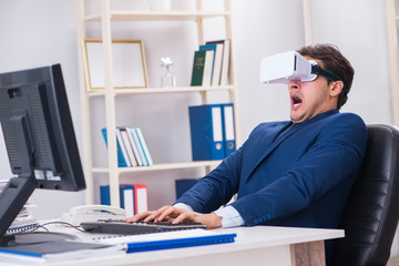 Employee using virtual reality glasses in office