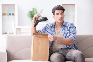 Man receiving wrong parcel with female woman shoes