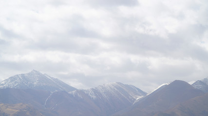 Fototapeta premium Mountain with some cloud on the blue clear sky