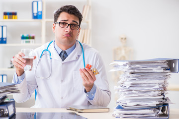 Busy doctor with too much work in hospital