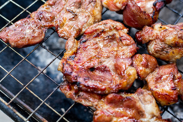 Grilled meat and steak on a grilled with smoke.