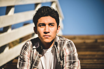 Young hispanic latino male looking off into the distance, serious facial expression  - Powered by Adobe
