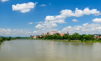 Fototapeta na wymiar Ptuj, Slovenia, panoramic shot of oldest city in Slovenia with a castle overlooking the old town from a hill, clouds time lapse