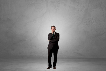 Obraz premium Alone handsome businessman standing in a dark empty room