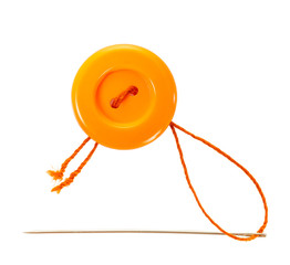 orange button with thread and needle