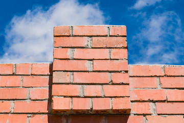 Red brick wall with towers patterns for text, copyspace, close-up   © golubka57