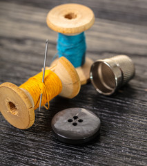 Thread with a thimble and button