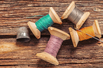 colored threads and thimble