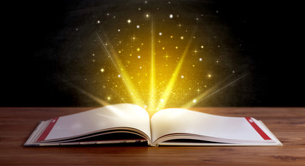 Yellow lights and sparkles coming from an open book 