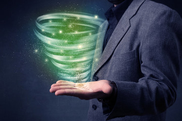 Bright green tornado in the hands of a businessman 