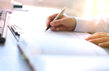 Businesswoman hands pointing at business document.