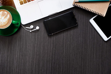 office stuff with tablet, laptop ,smartphone and coffee cup notepad top view shot.