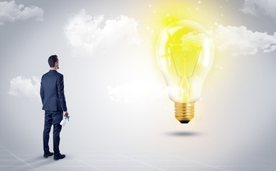 Fototapeta premium Businessman standing with his back with objects in his hand and looking at the globe, courtesy of NASA 