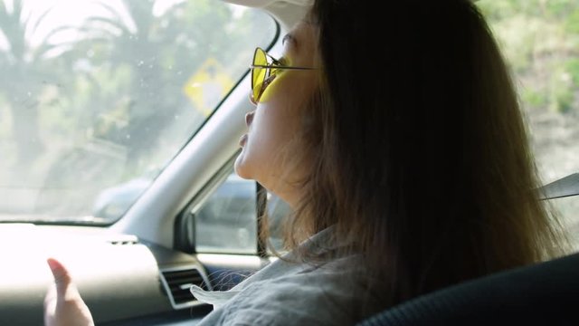 Closeup Of Fun Young Woman Dancing And Singing To Her Friend (The Driver) On A California Road Trip - Shot On Red Scarlet-W Dragon In 4K, Slow Motion