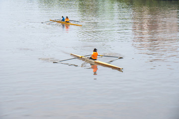 Young sportsmen in a boat, rowing on the river Rioni, Poti, Georgia