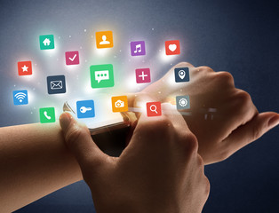 Naked female hand with smartwatch and  application labels around and dark background