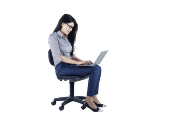 Pretty businesswoman with laptop on the chair