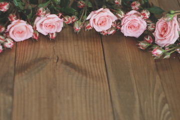 Pink Beautiful Roses Bouquet over Wooden Table. Top view Copy Space. Vintage Greeting Card