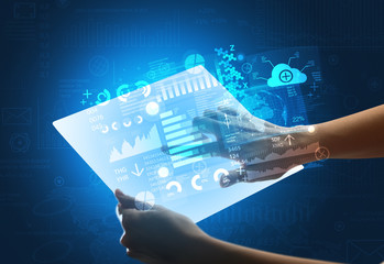 Young female hand holding a tablet with blue graphs 