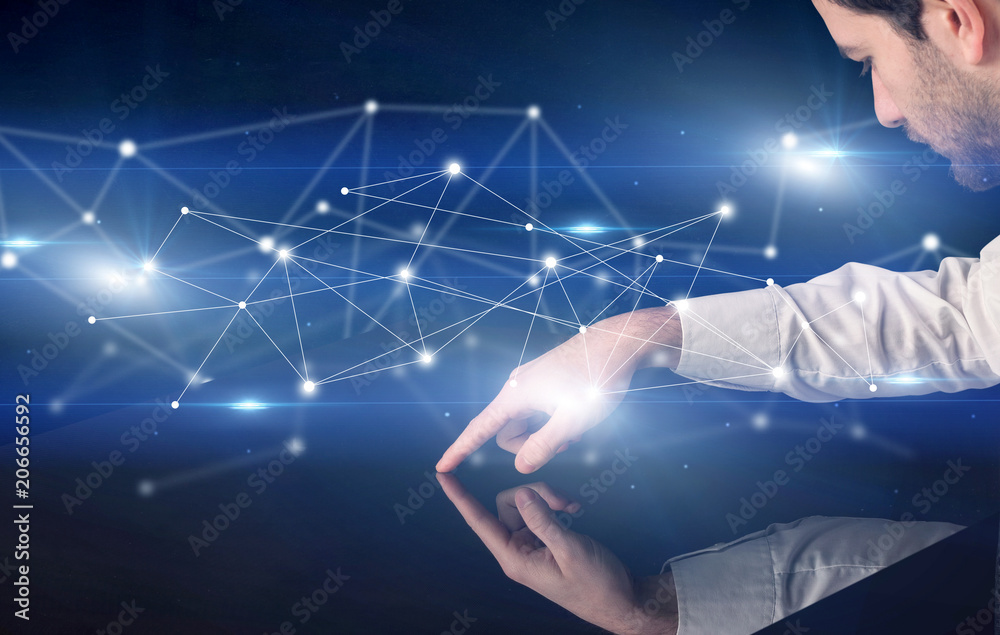 Poster male hands touching interactive table with blue connectivity graphic in the background