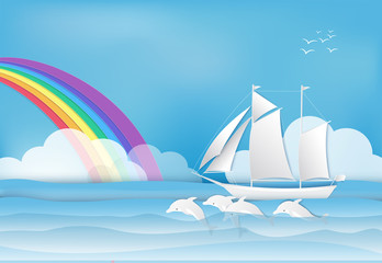 Naklejka premium Sailing ship with Dolphin in the sea and rainbow on blue sky background