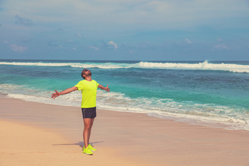 Exercising on a tropical sandy beach near sea / ocean.