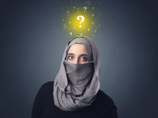 Young muslim woman wearing niqab with yellow question marks above her head