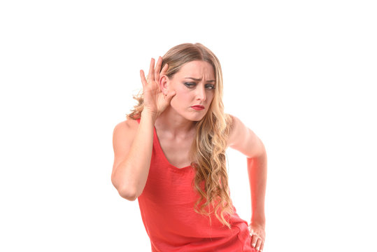 Young woman holding her hand to her ear