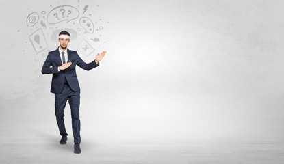 Fototapeta premium Young businessman in suit fighting with doodled symbols concept 