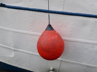 orange colored buoy on a white ship