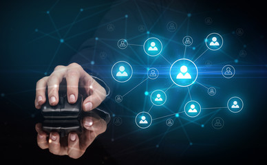 Hand using wireless mouse in a dark environment with human network concept