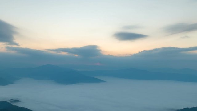 Foggy morning with sunrise on top of mountain, timelapse