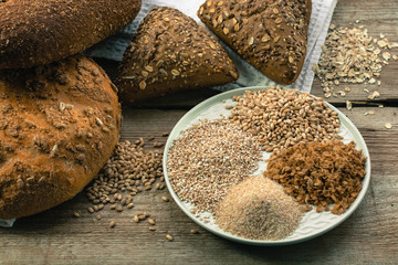 Whole grain bread. Assortment of multi-grain bread on old wooden table. Сoncept of healthy eating.