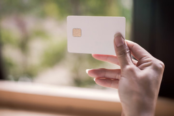 Closeup the hand of businessman is holding hand credit card and hand of businesswoman reading text message on mobile phone in network, and using smartphone. Online payments plastic card .