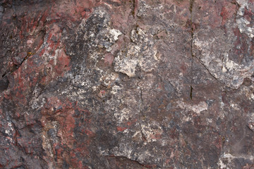 Texture of mottled red natural stone, close-up