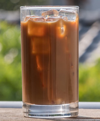 Iced milk coffee over wooden background