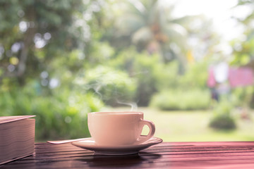 hot coffee on wooden table at garden