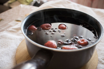 compote with berries in the ladle