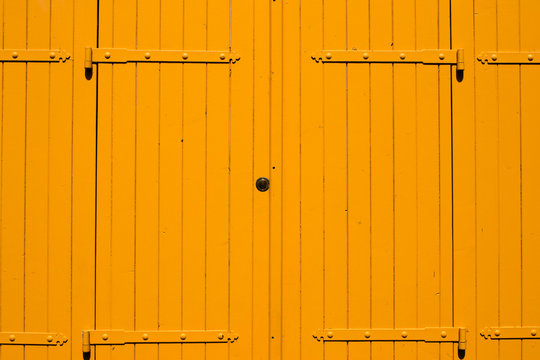 Yellow wooden doors in Paris, France