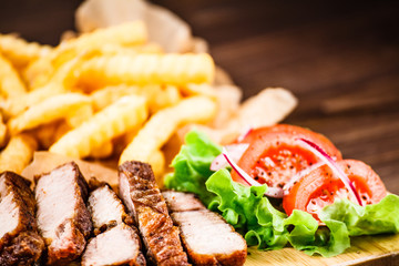 Grilled beefsteak with french fries and vegetables