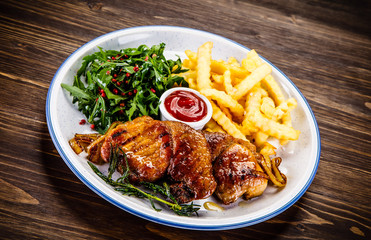 Grilled beefsteak with french fries and vegetable salad